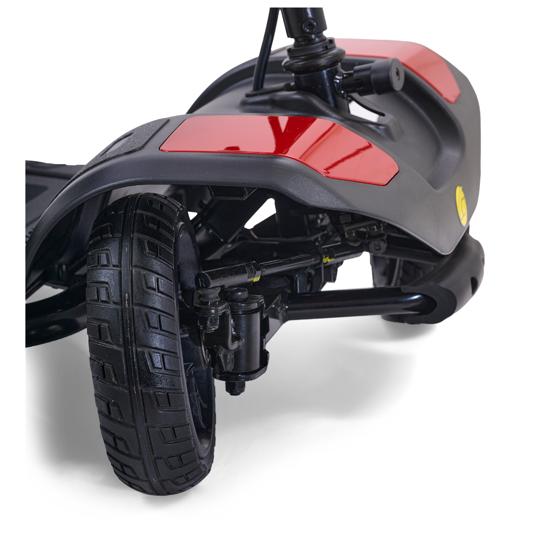 Close-up of the Golden Tech GB108 Buzzaround LT 4-Wheel Mobility Scooter’s black front wheel, highlighting its tire tread, suspension system, and red reflector. This model supports up to 300 lbs for reliable performance.