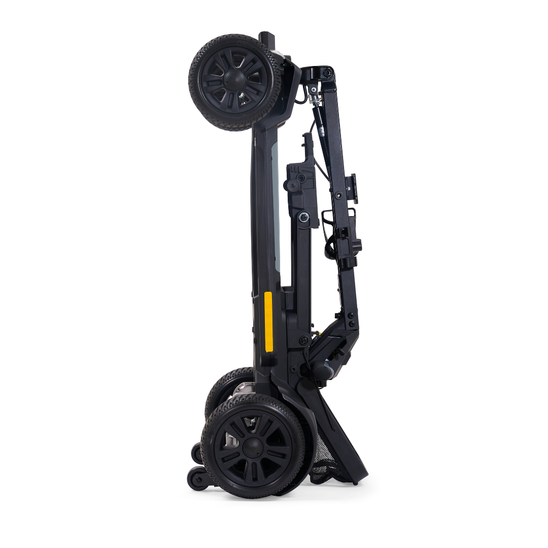 The Golden Buzzaround GB220 CarryOn HD Travel Scooter is a compact, black, foldable mobility scooter that stands upright when folded, highlighting its lightweight and streamlined design for easy travel.