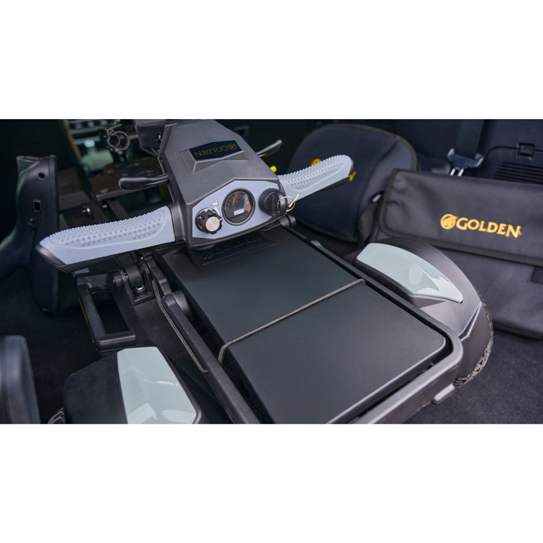 Close-up of the control panel and armrests of the Golden Buzzaround GB220 CarryOn HD Travel Scooter, with a black Golden-branded carrying case next to it.