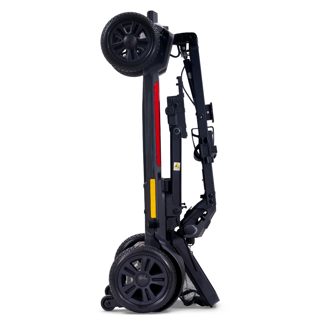 A black folding stroller stands upright on its wheels in a fully folded position, similar to the compact Golden Buzzaround GB220 CarryOn HD Travel Scooter with its impressive 400 lb weight capacity.