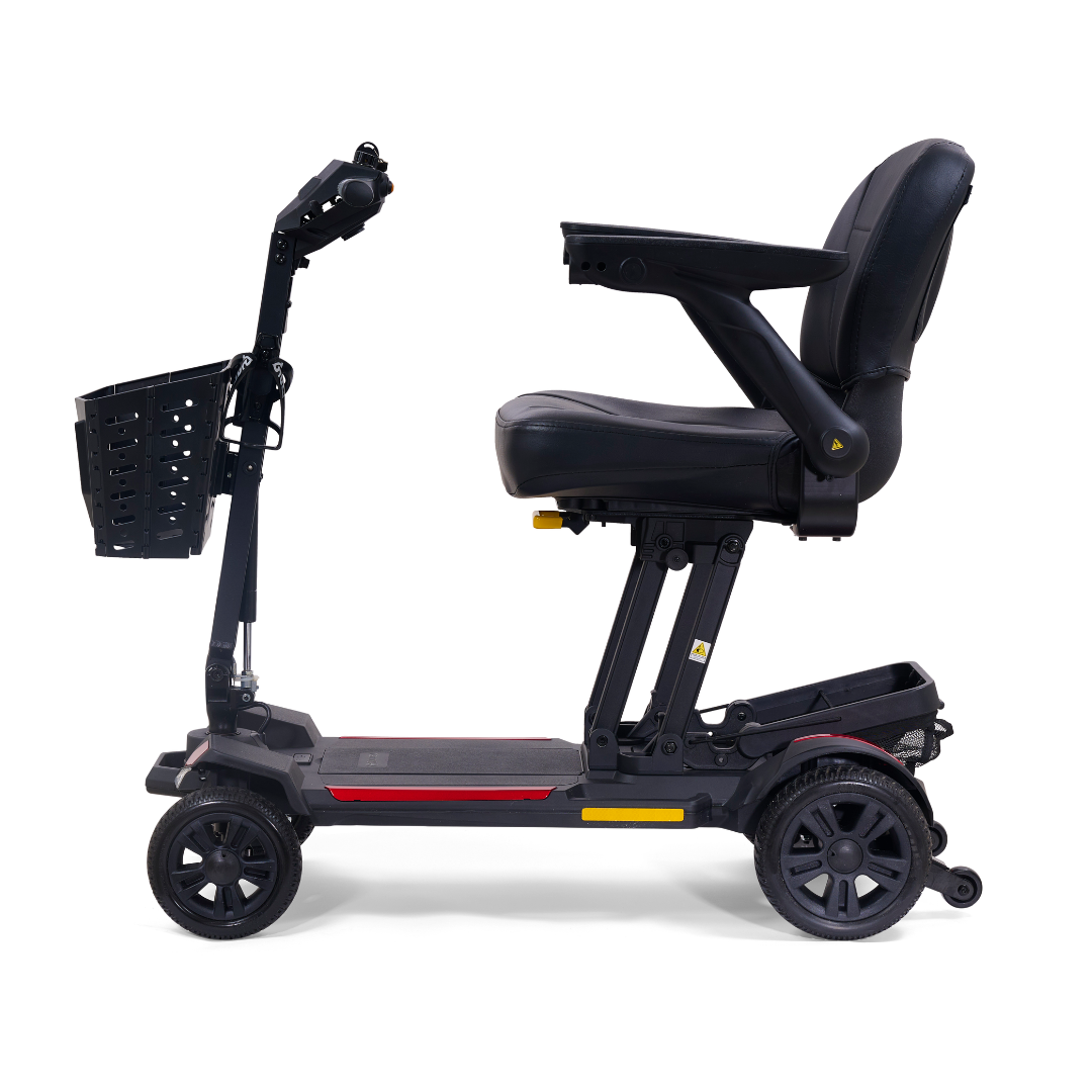 A side view of the Golden Buzzaround GB220 CarryOn HD Travel Scooter, a black, lightweight four-wheel mobility scooter with padded seat, armrests, front basket, and 400 lb weight capacity for personal transportation and accessibility.
