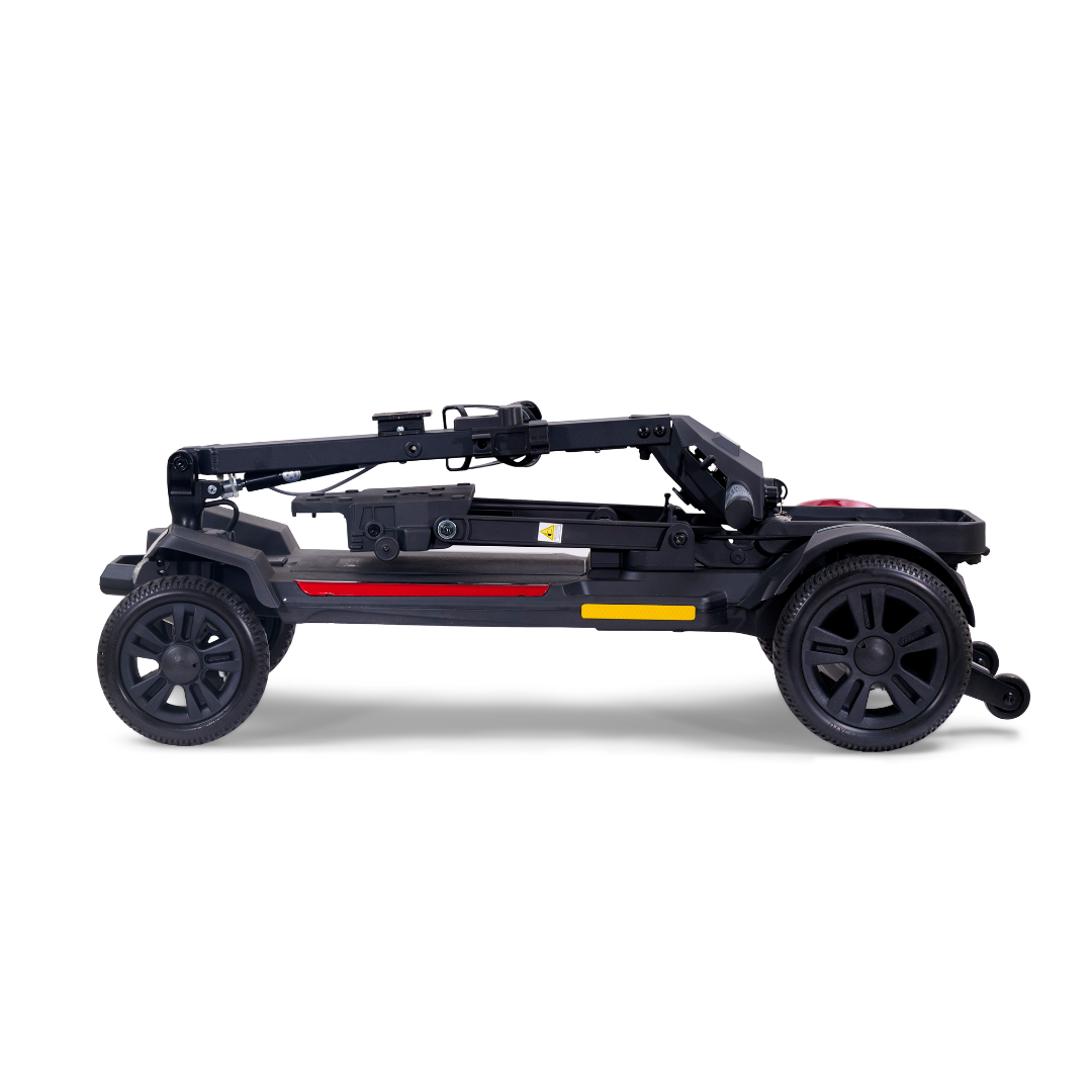 A compact, folded Golden Buzzaround GB220 CarryOn HD Travel Scooter shown from the side. This lightweight model has three wheels—large rear and smaller front—with red and yellow frame accents and a 400 lb weight capacity.