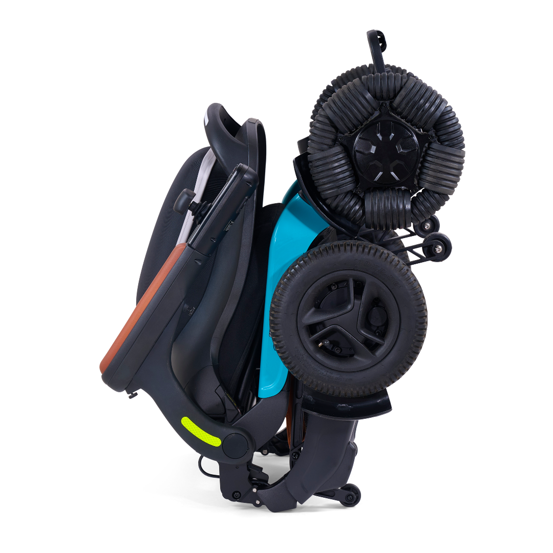 The Golden Tech Ally Pro Smart All-Terrain Power Wheelchair, in a black and teal scheme, features omni-directional wheels for enhanced maneuverability. It’s compact with visible wheels and a sleek seat, highlighting its portable design infused with advanced robotics technology.