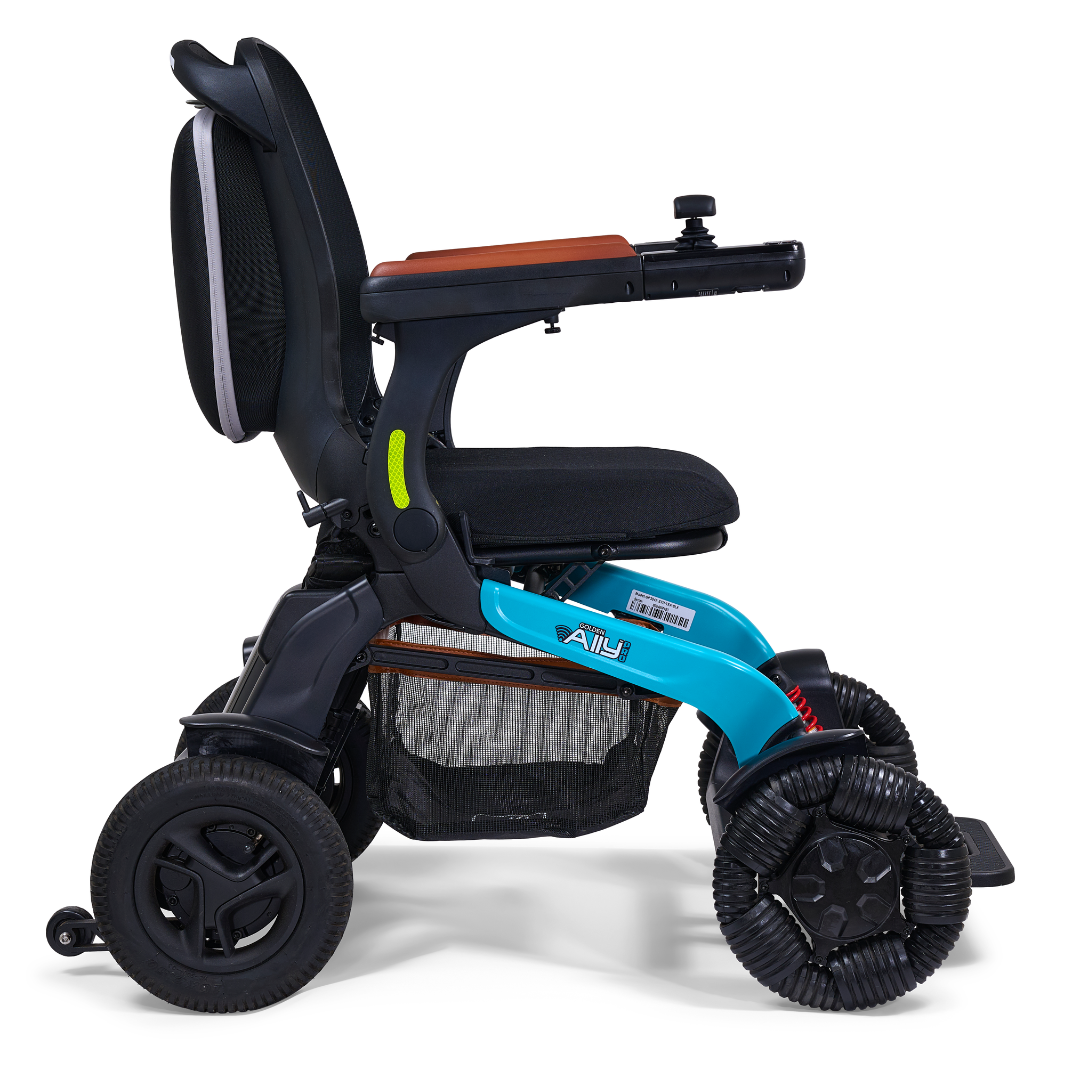 The Golden Tech Ally Pro Smart All-Terrain Power Wheelchair features a blue frame, an adjustable black seat, and omni-directional wheels for superior maneuverability. It includes a right armrest control panel and APP control.