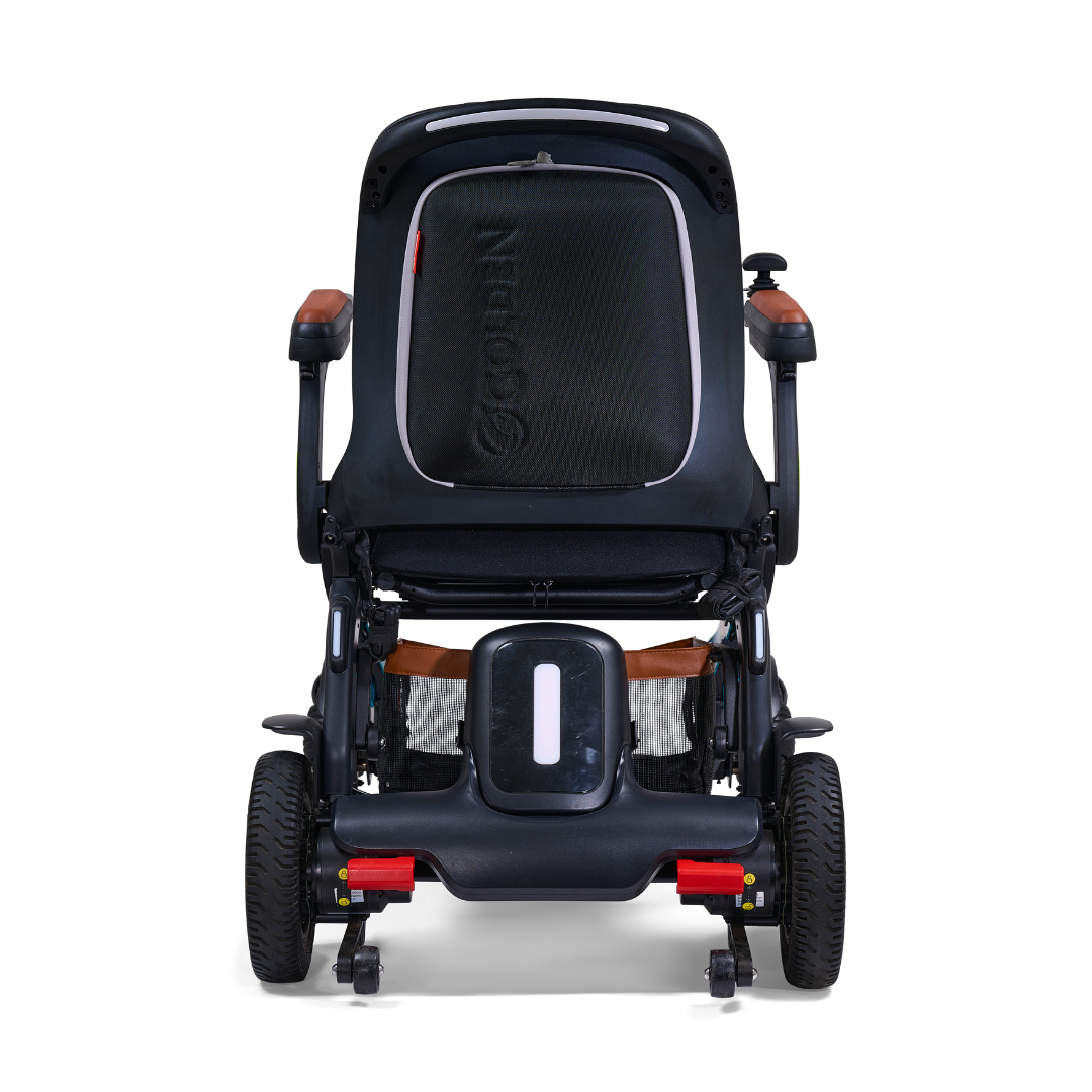 The Golden Tech Ally Pro Smart All-Terrain Power Wheelchair, shown from the rear, features omni-directional wheels and a sleek black design. It includes a seat with a white stripe, armrests with brown accents, visible handles for pushing, and combines modern style with smart power technology.