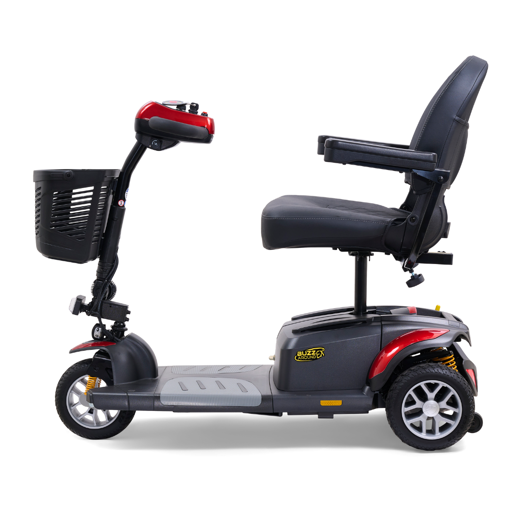 The Golden Tech GB118 Buzzaround EX Portable Mobility Scooter includes a black seat, red accents, and a front basket. This lightweight three-wheel scooter has an intuitive control panel on the handlebars and a footrest for user comfort.