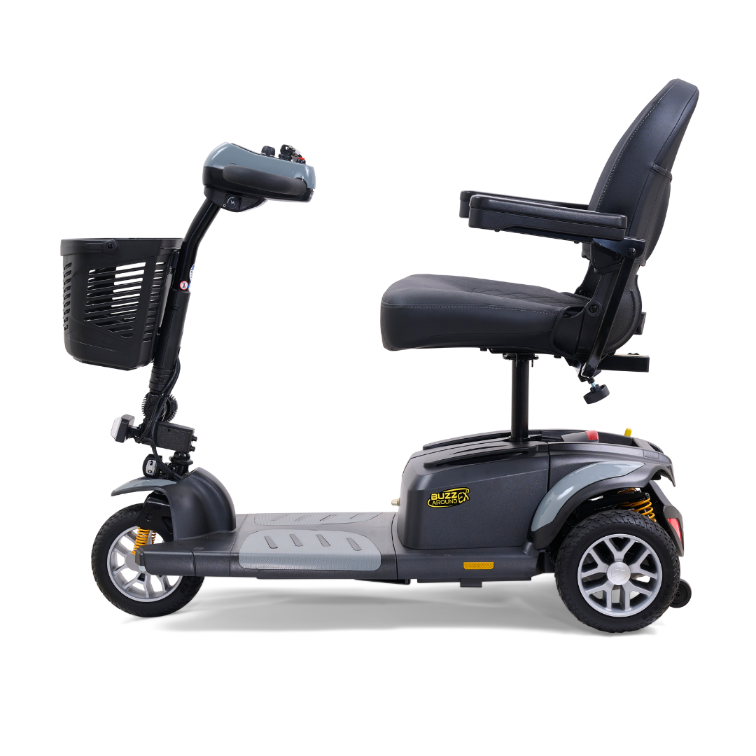 Side view of the Golden Tech GB118 Buzzaround EX Portable Mobility Scooter, featuring three wheels, a padded seat with armrests, a front basket, intuitive tiller and controls. This lightweight black scooter displays Buzz branding on the base.