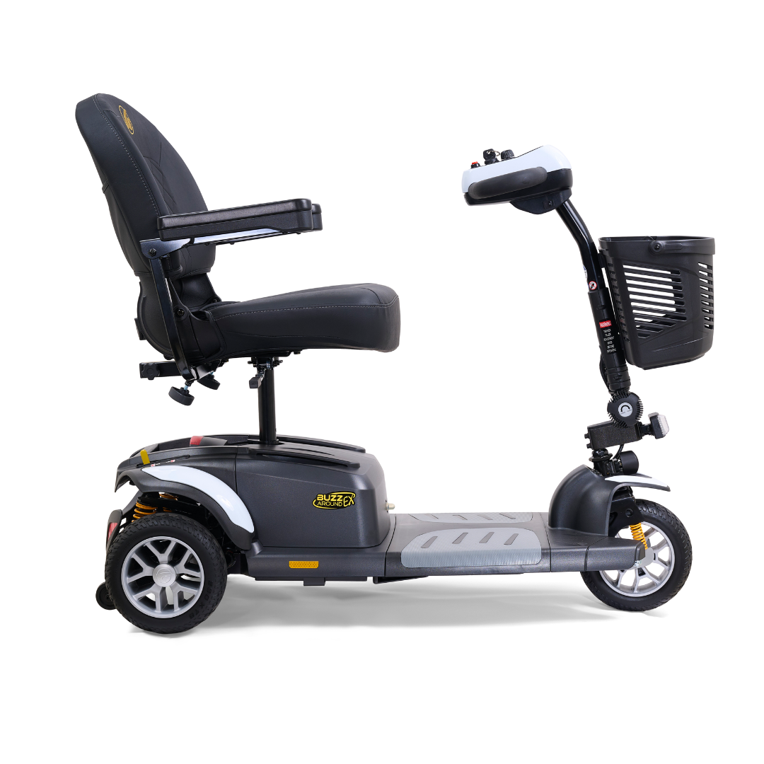 Side view of the Golden Tech GB118 Buzzaround EX Portable Mobility Scooter in black and gray, featuring a comfortable seat, armrests, a handlebar basket, three wheels, padded backrest, and a compact design ideal for personal transportation.