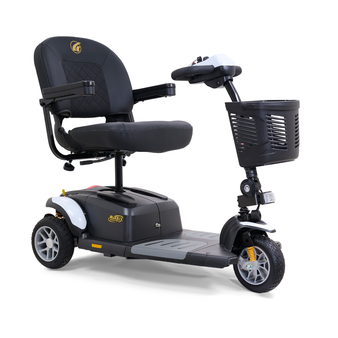The Golden Tech GB118 Buzzaround EX Portable Mobility Scooter is shown in black and gray with three wheels. It features a padded seat, armrests, a control panel, and a front basket. This full-size scooter design ensures stability and ease of use.