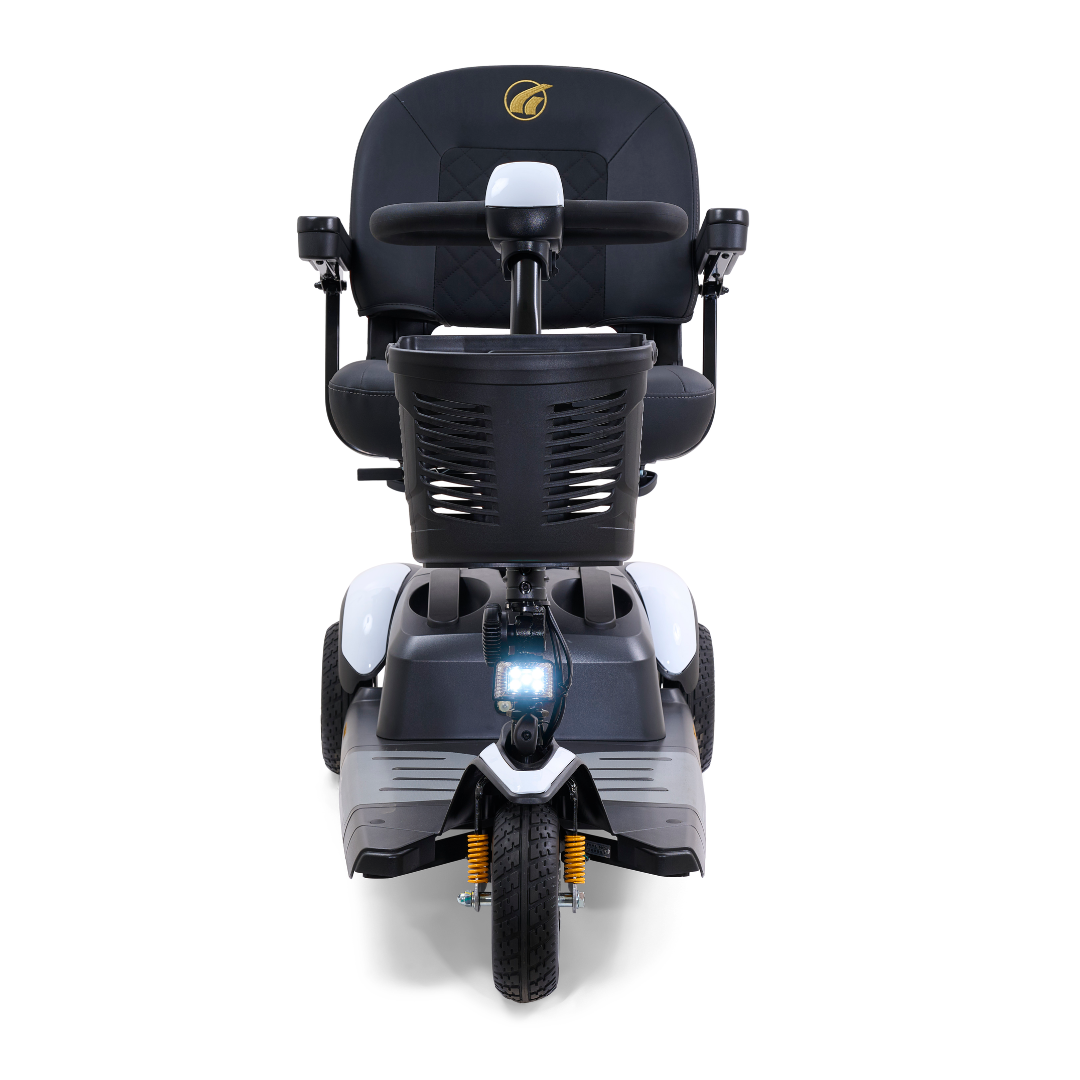 The Golden Tech GB118 Buzzaround EX Portable Mobility Scooter showcases a padded seat, armrests, steering handle, front basket, and headlight. This lightweight model features one front wheel and two rear wheels to assist those with mobility challenges.