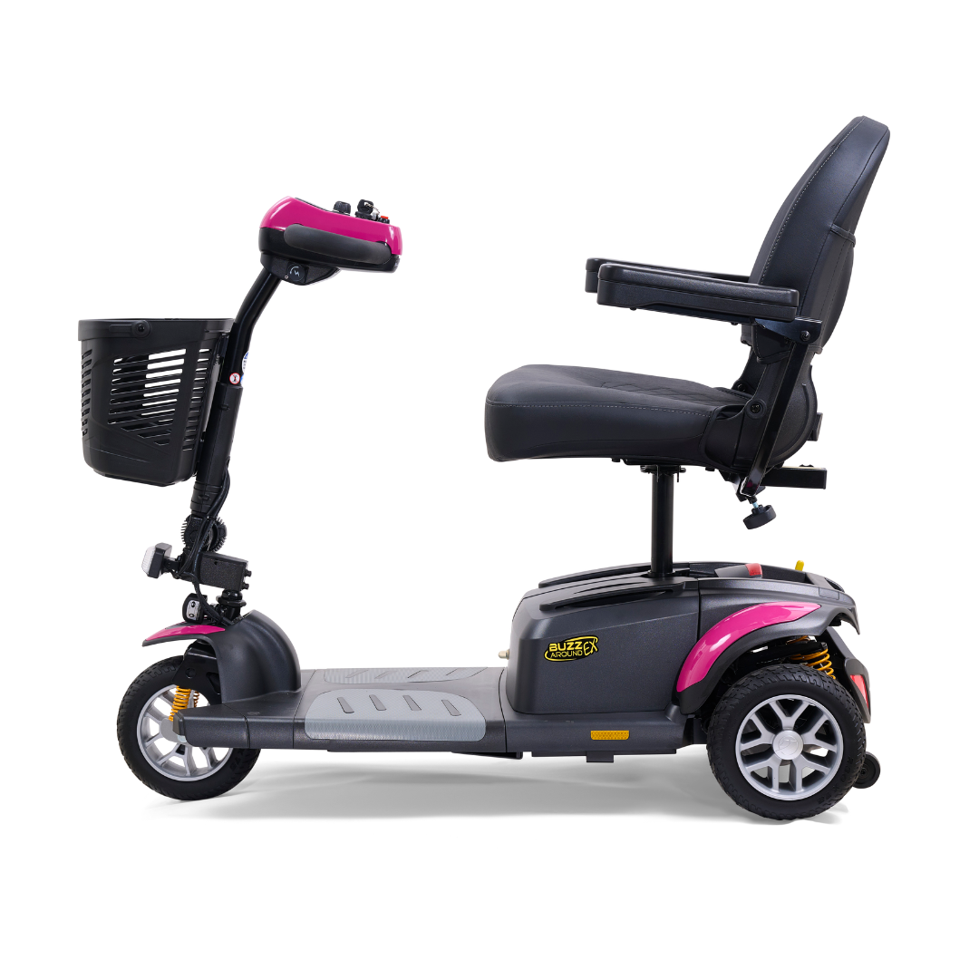 Side view of a black and pink Golden Tech GB118 Buzzaround EX 3-wheel mobility scooter featuring a cushioned seat, handlebar controls, and front basket. Its designed for personal transportation with a compact and sturdy appearance.