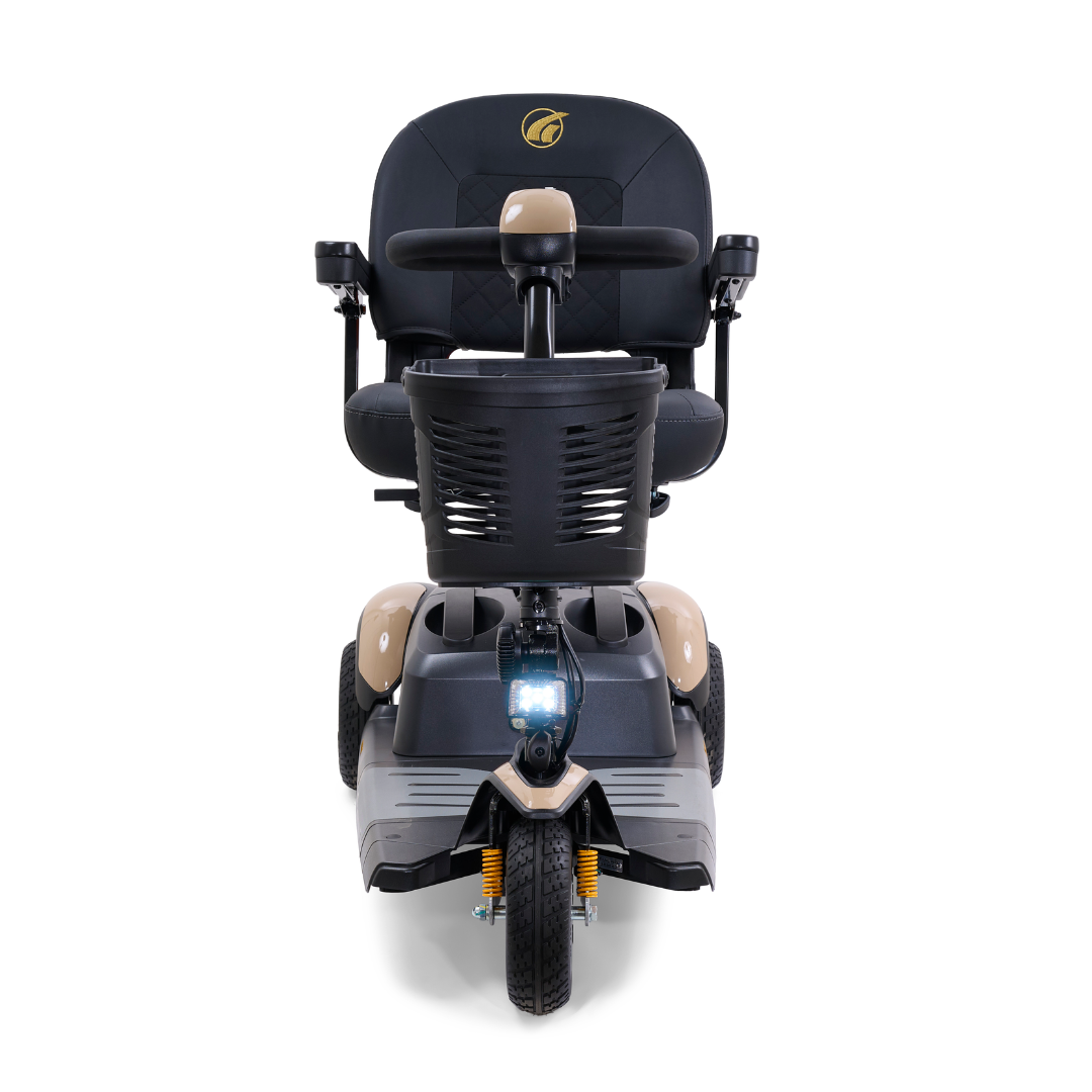 The Golden Tech GB118 Buzzaround EX Portable Mobility Scooter features a beige frame with a black seat and handlebars, three wheels, a grid-design front basket, visible suspension springs for comfort, and a central headlight.