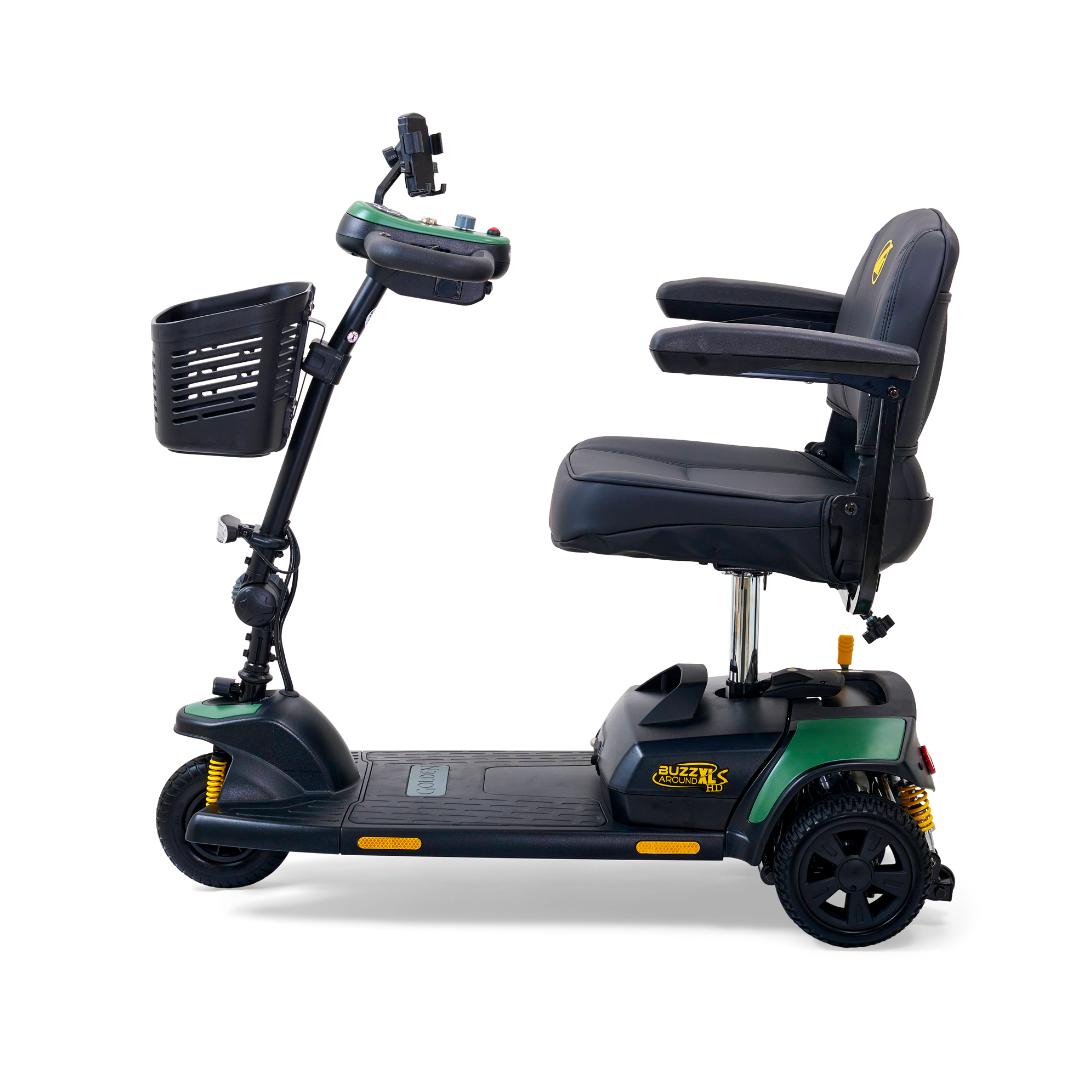 Side view of a green and black Golden Tech GB121 Buzzaround XLS HD scooter with a delta tiller, padded seat, armrests, handlebar controls, and front basket. Featuring three wheels and Comfort Spring Suspension for enhanced comfort.