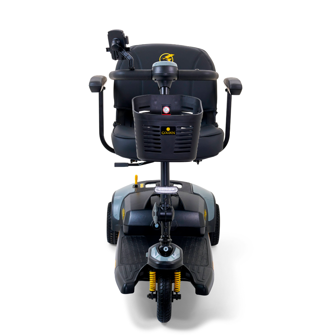 The Golden Tech GB121 Buzzaround XLS HD is a black and gray 3-wheel portable scooter, featuring a padded seat with armrests, handlebars with Delta tiller, suspension, headlight, and visible brand logo on the seat back. Viewed from the front.