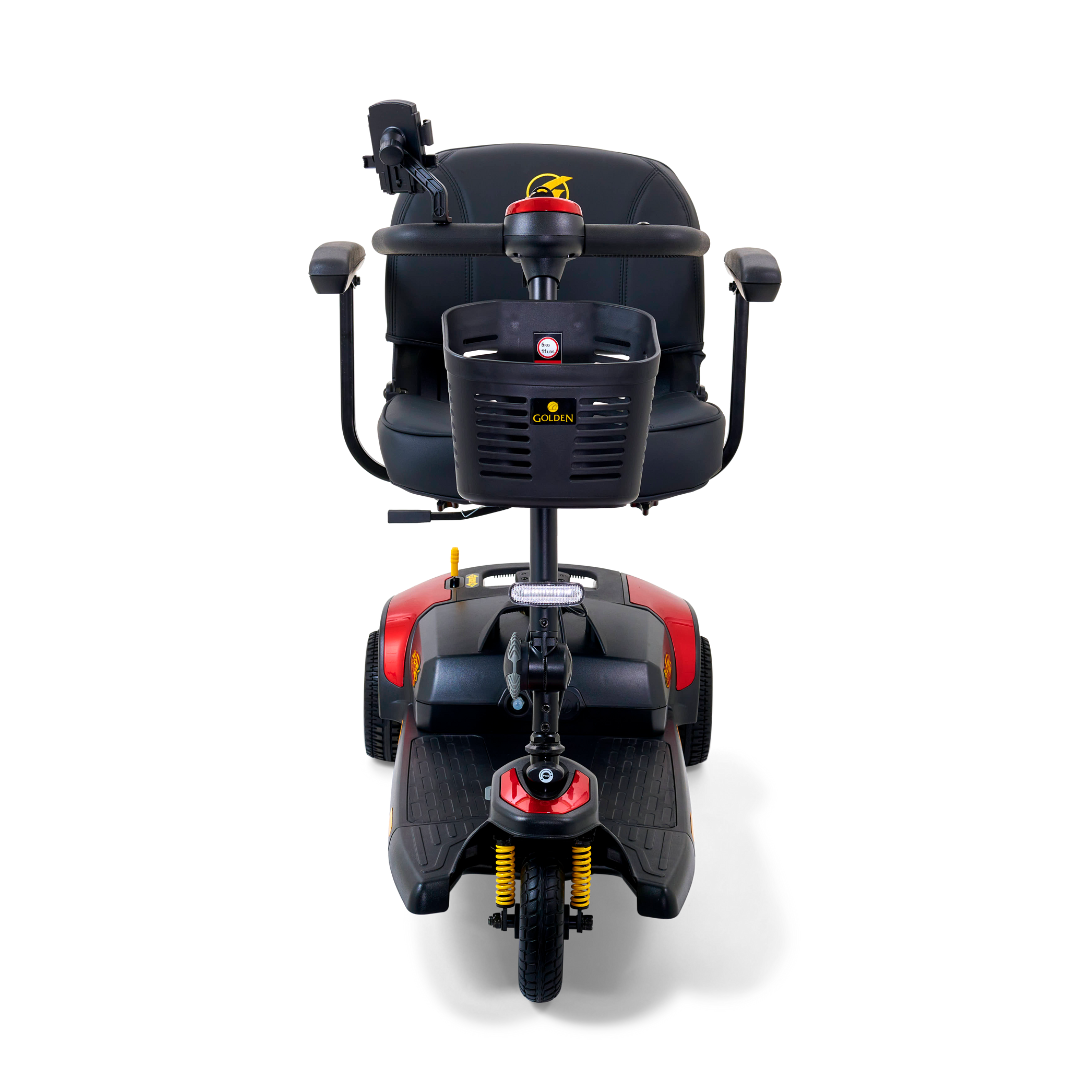 The Golden Tech GB121 Buzzaround XLS HD 3-Wheel Portable Scooter features a front view with a black design, red accents, padded seat, armrests, handlebars, and a front basket. Comfort Spring Suspension provides smooth rides while the Delta tiller allows easy control for effortless maneuvering.