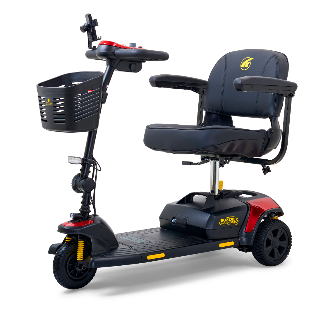 The Golden Tech GB121 Buzzaround XLS HD 3-Wheel Portable Scooter is a compact black and red mobility scooter with a cushioned stadium-style seat, armrests, handlebar basket, control panel, and Comfort Spring Suspension featuring yellow components on the front wheel for smooth rides.