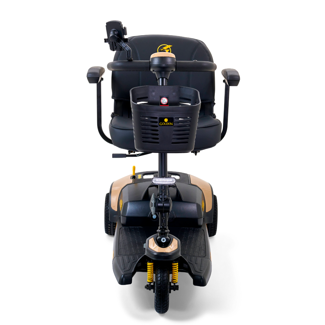 An image of the Golden Tech GB121 Buzzaround XLS HD 3-Wheel Portable Scooter shows its black seat and armrests, with a sleek black and gold body and attached basket. Designed for accessibility, it includes handle control panels and Comfort Spring Suspension for smoother rides.