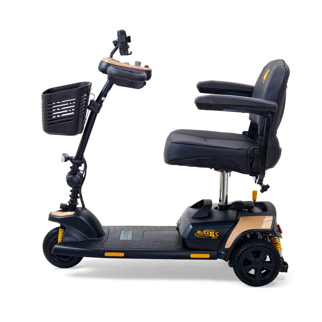 The Golden Tech GB121 Buzzaround XLS HD 3-wheel portable scooter in black boasts a stadium-style seat, armrests, Delta tiller for easy navigation, Comfort Spring Suspension for smooth rides, a front storage basket, and yellow branding.