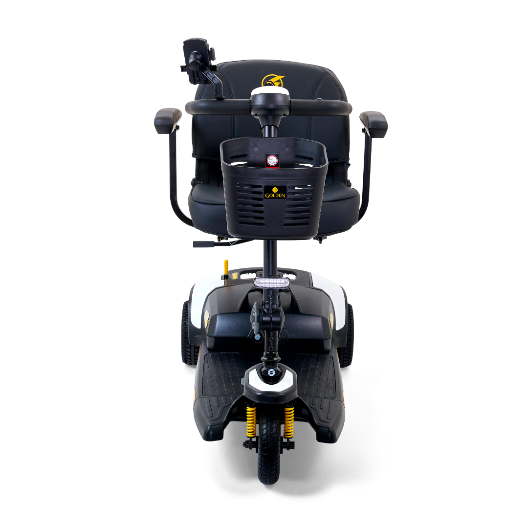 Front view of the Golden Tech GB121 Buzzaround XLS HD mobility scooter in black, showcasing its Delta tiller, padded stadium seat with armrests, handlebar basket, three wheels, Comfort Spring Suspension for smooth rides, and a logo on the backrest.