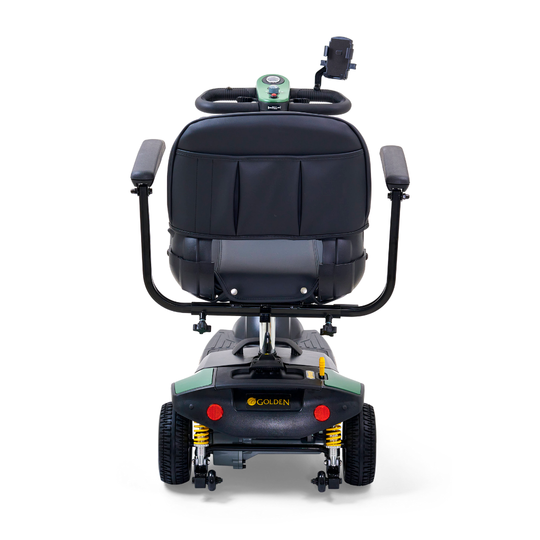 The Golden Tech GB121 Buzzaround XLS HD 3-Wheel Portable Scooter has a rear view showing armrests and a Delta tiller. It features large wheels and Comfort Spring Suspension for a smooth ride, with its logo on the back and a small handle on the right side.