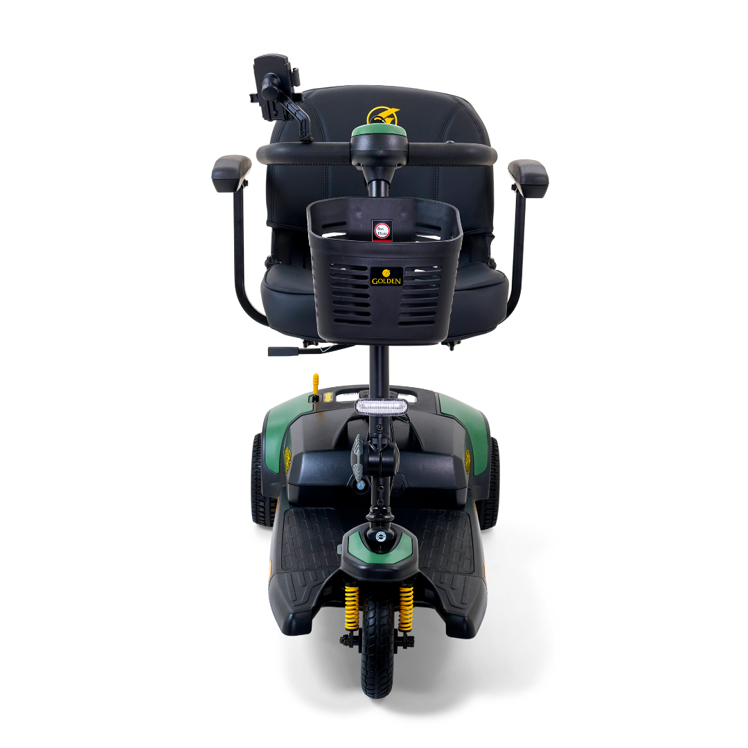 The Golden Tech GB121 Buzzaround XLS HD 3-Wheel Portable Scooter offers a padded seat with armrests, front storage basket, sturdy wheels, and a delta tiller with handlebar controls. The base features green and black accents, while the Comfort Spring Suspension ensures enhanced comfort.