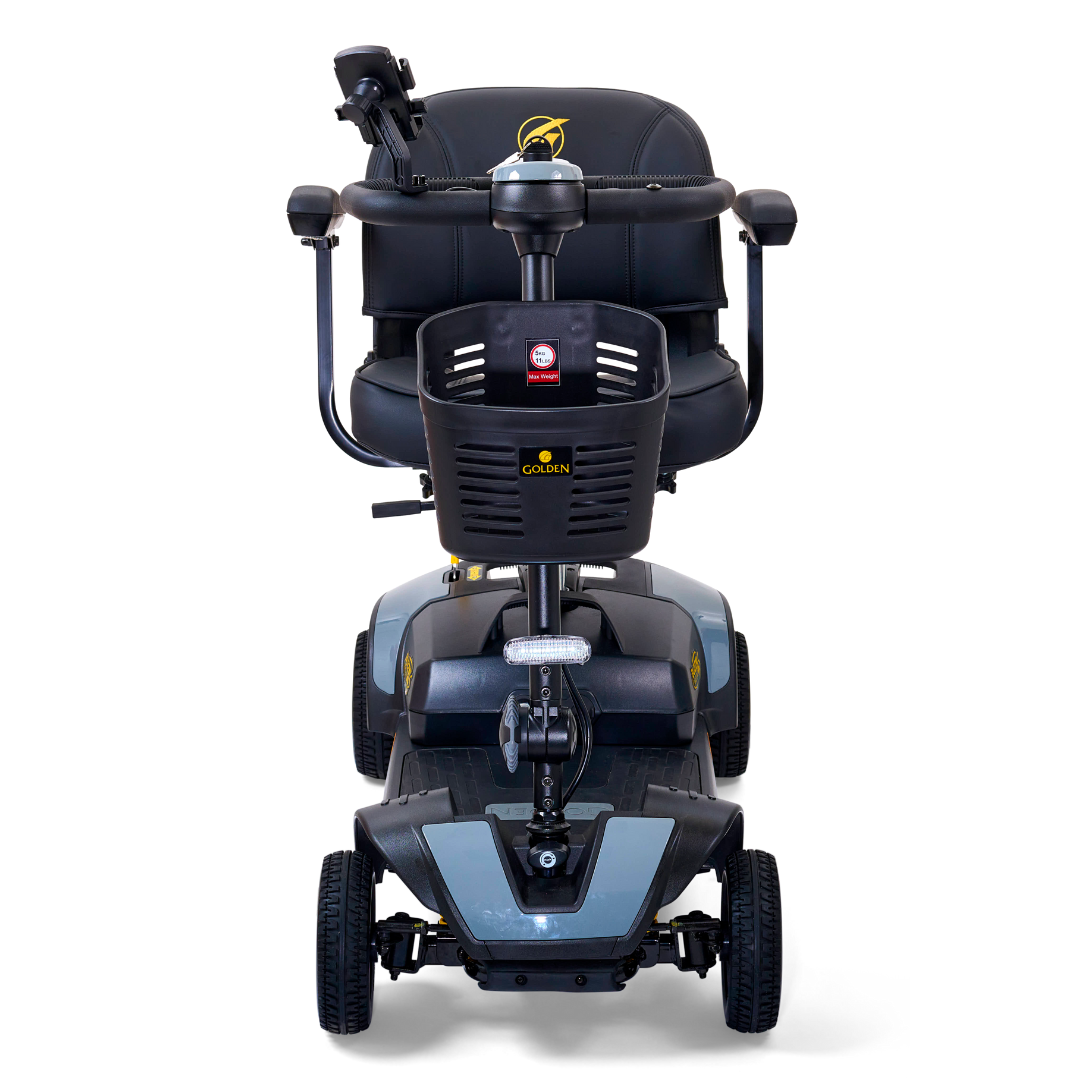 Front view of the Golden Tech GB124 Buzzaround XLS HD 4-Wheel Portable Scooter in black, showcasing a comfortable seat, armrests, Delta tiller steering handle for easy control, four wheels with suspension, and the XR Extended Range Battery. The brand logo is prominently displayed on the front panel.