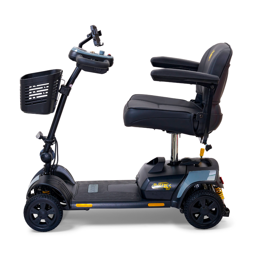 The Golden Tech GB124 Buzzaround XLS HD is a black, 4-wheel portable scooter featuring cushioned seating with armrests, handlebars with controls, and a front basket. Its sturdy tires and Comfort Spring Suspension improve ride quality, making it perfect for personal transportation.