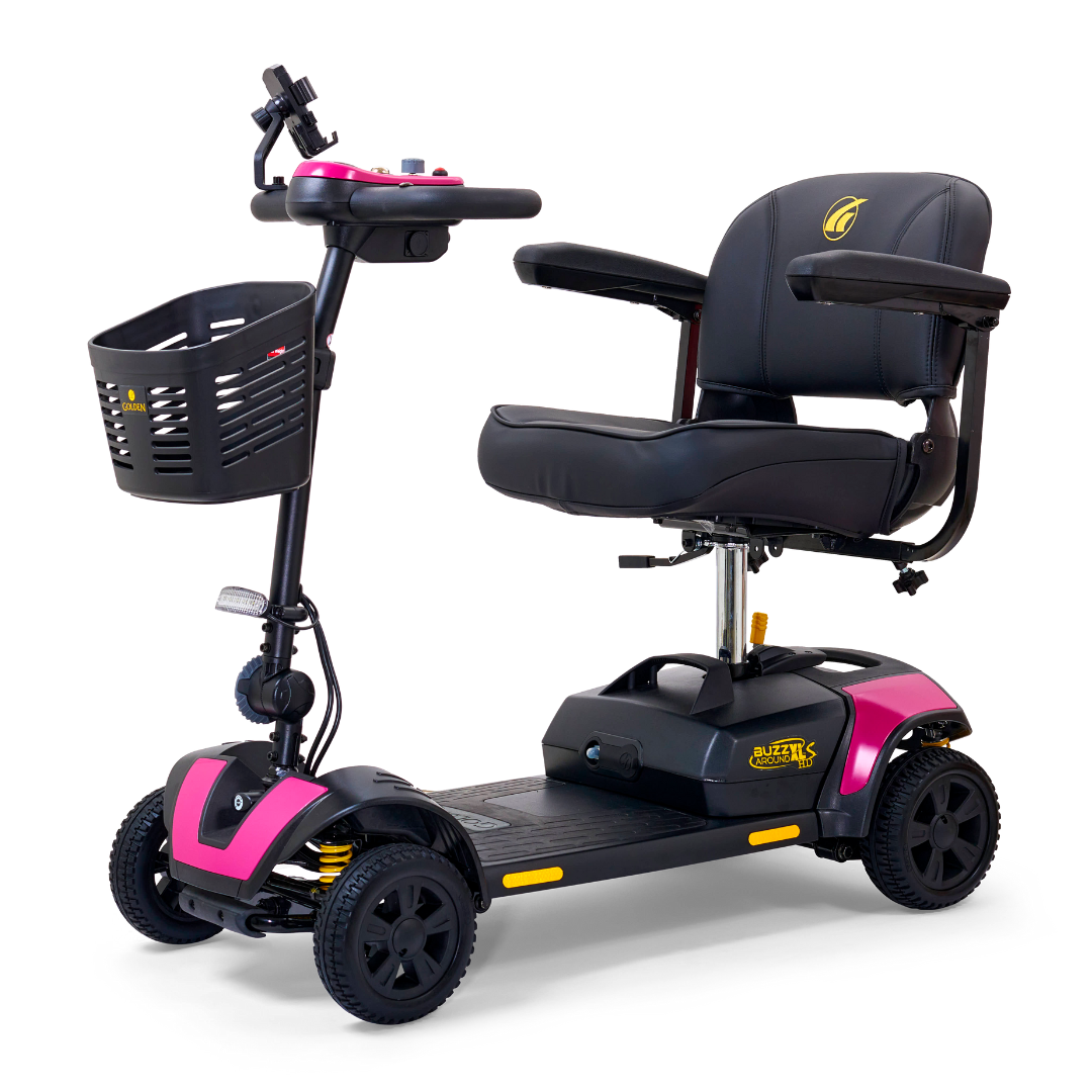 The Golden Tech GB124 Buzzaround XLS HD is a stylish 4-wheel portable scooter with a pink and black frame, black seat and armrests, front basket, and Comfort Spring Suspension for smooth rides, equipped with control handles for easy maneuvering.