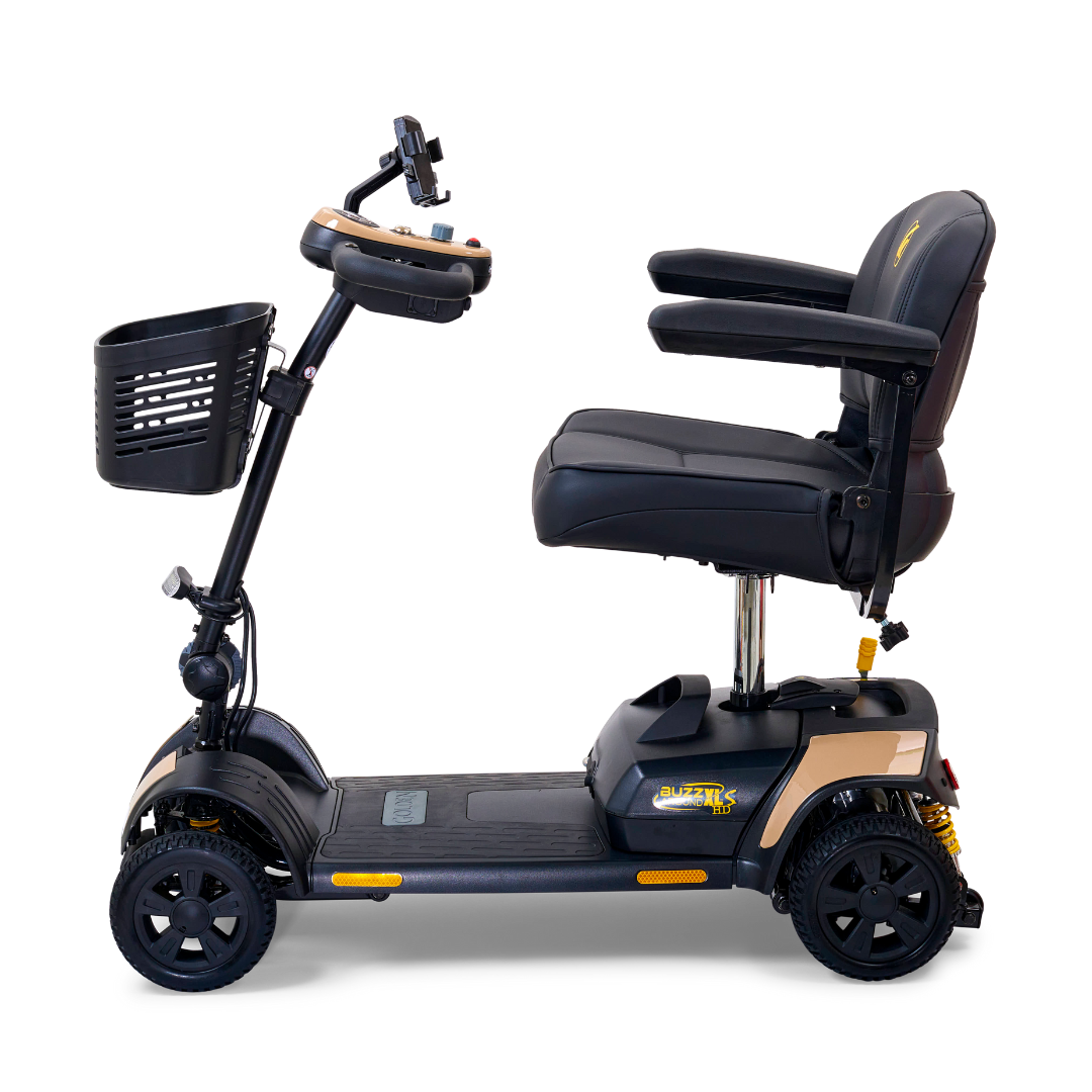 The Golden Tech GB124 Buzzaround XLS HD is a black 4-wheel portable scooter with a padded seat, armrests, and a front basket. It has Comfort Spring Suspension for smooth rides, handlebars with controls, a rearview mirror for safety, and a compact design for both indoor and outdoor use.