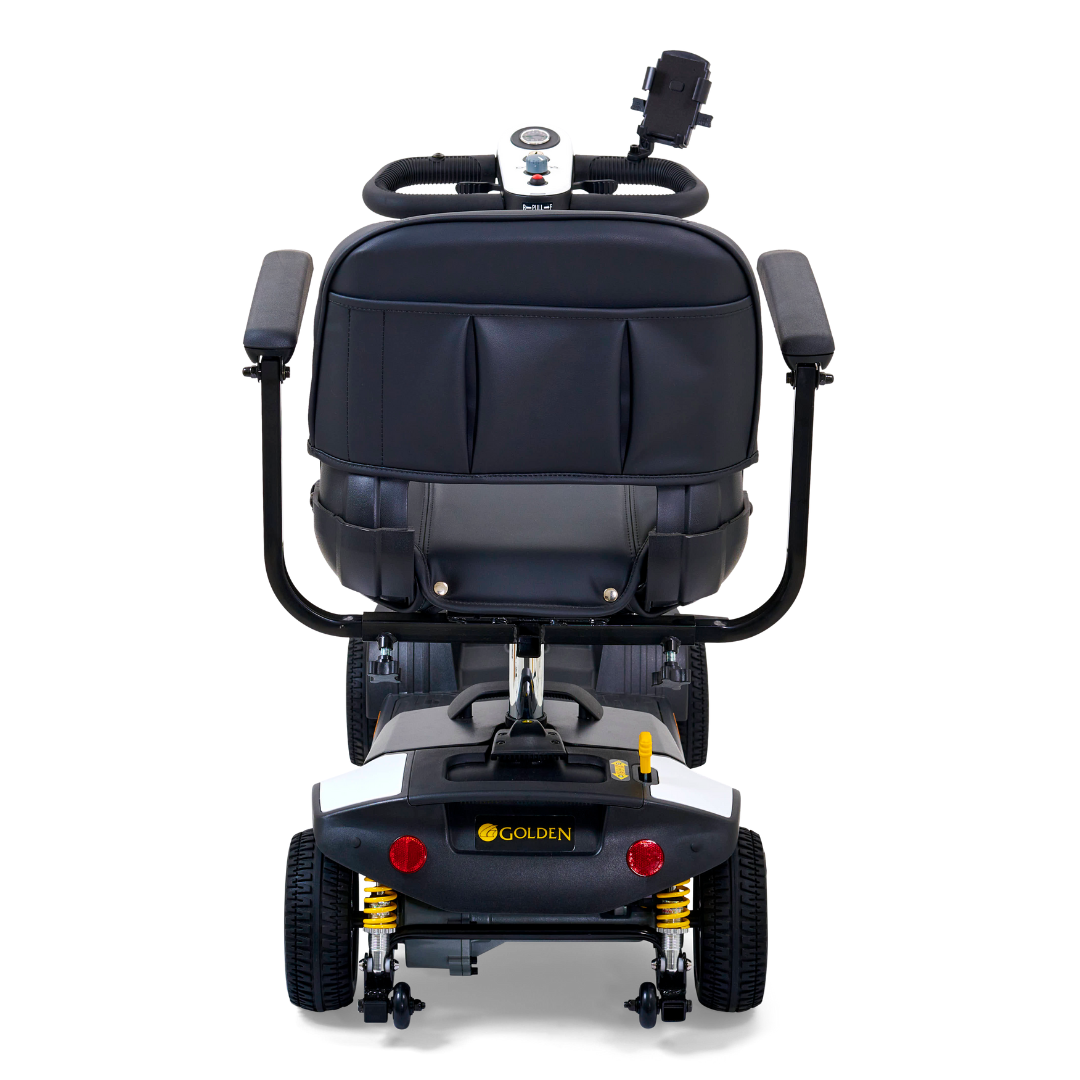 The Golden Tech GB124 Buzzaround XLS HD 4-Wheel Portable Scooter features a rear view of a black cushioned seat with armrests, a control panel with speedometer, Comfort Spring Suspension, and includes a back storage compartment plus smartphone holder on the delta tiller.