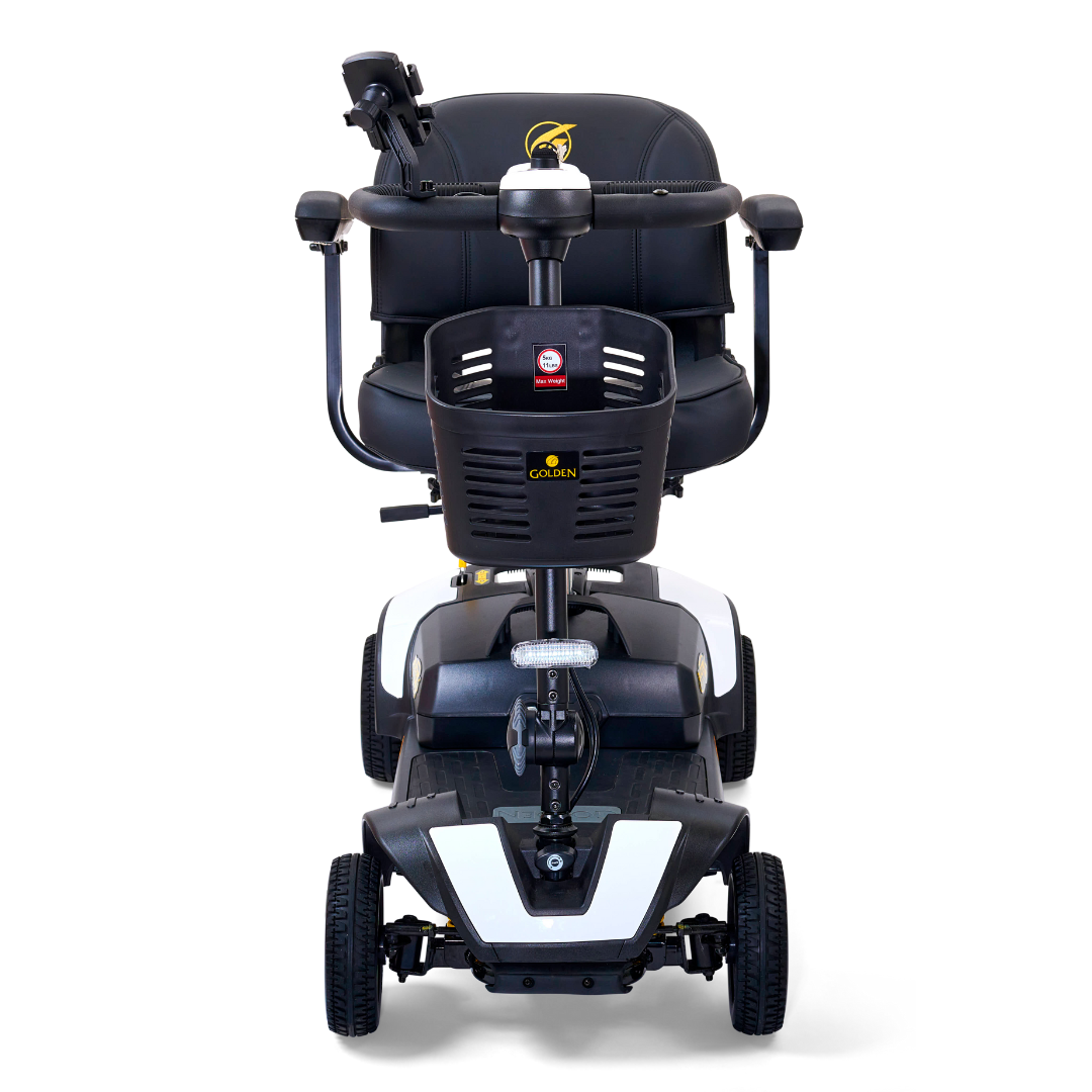 The front view of the Golden Tech GB124 Buzzaround XLS HD 4-Wheel Portable Scooter with Suspension displays a comfortable seat, armrests, control panel, and four wheels for stability. Equipped with a Delta tiller for easy steering, it stands against a plain white background in black and white colors.