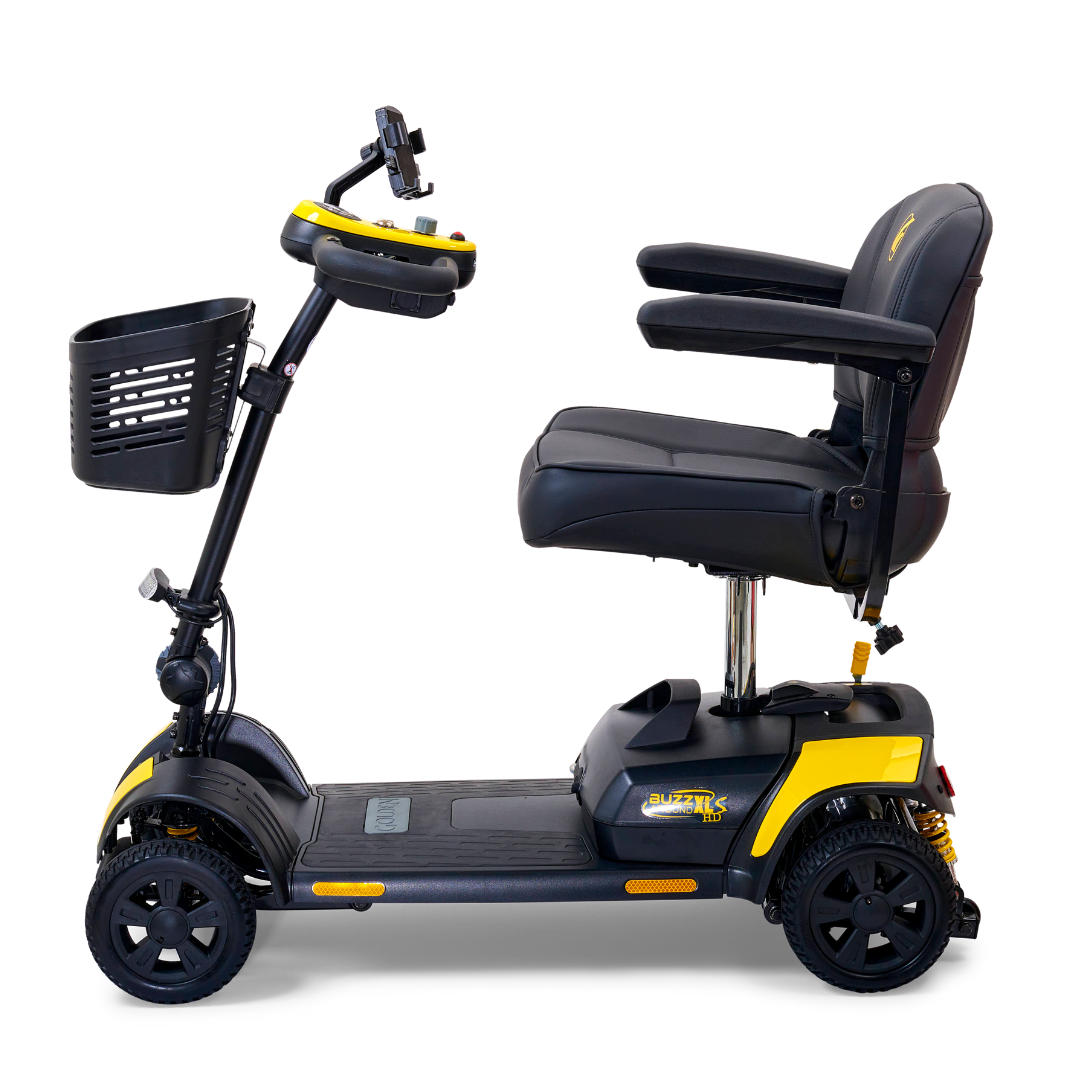 Side view of the Golden Tech GB124 Buzzaround XLS HD Scooter in yellow and black, showcasing Comfort Spring Suspension, a cushioned seat with armrests, a delta tiller control panel with handlebar, a front basket, and stable four-wheel design for smooth personal transportation.