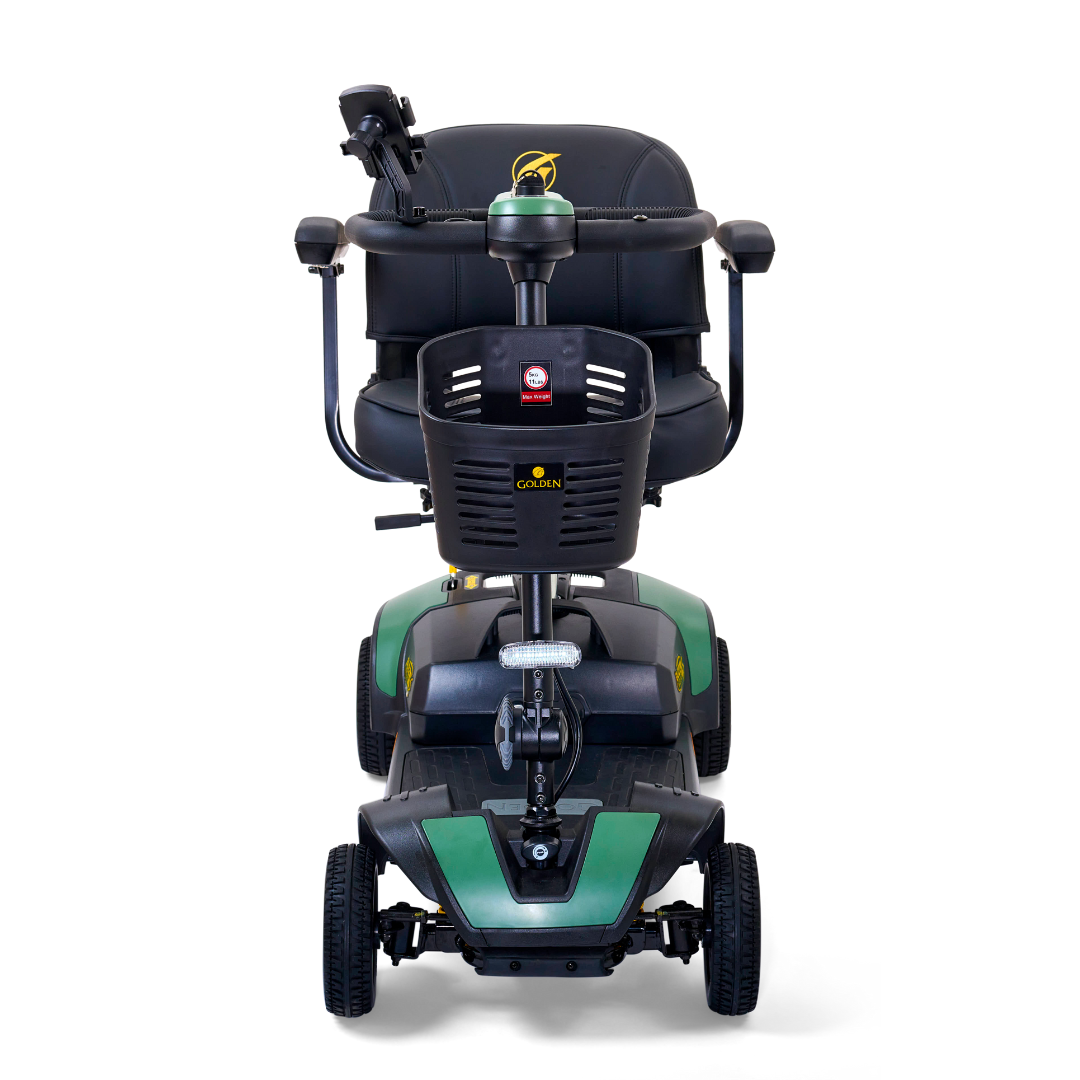 Front view of the Golden Tech GB124 Buzzaround XLS HD, a green and black 4-wheel scooter with a cushioned seat and handlebars. It features a Delta tiller for easy maneuvering, a control panel with the manufacturers logo, and Comfort Spring Suspension for a smooth ride.