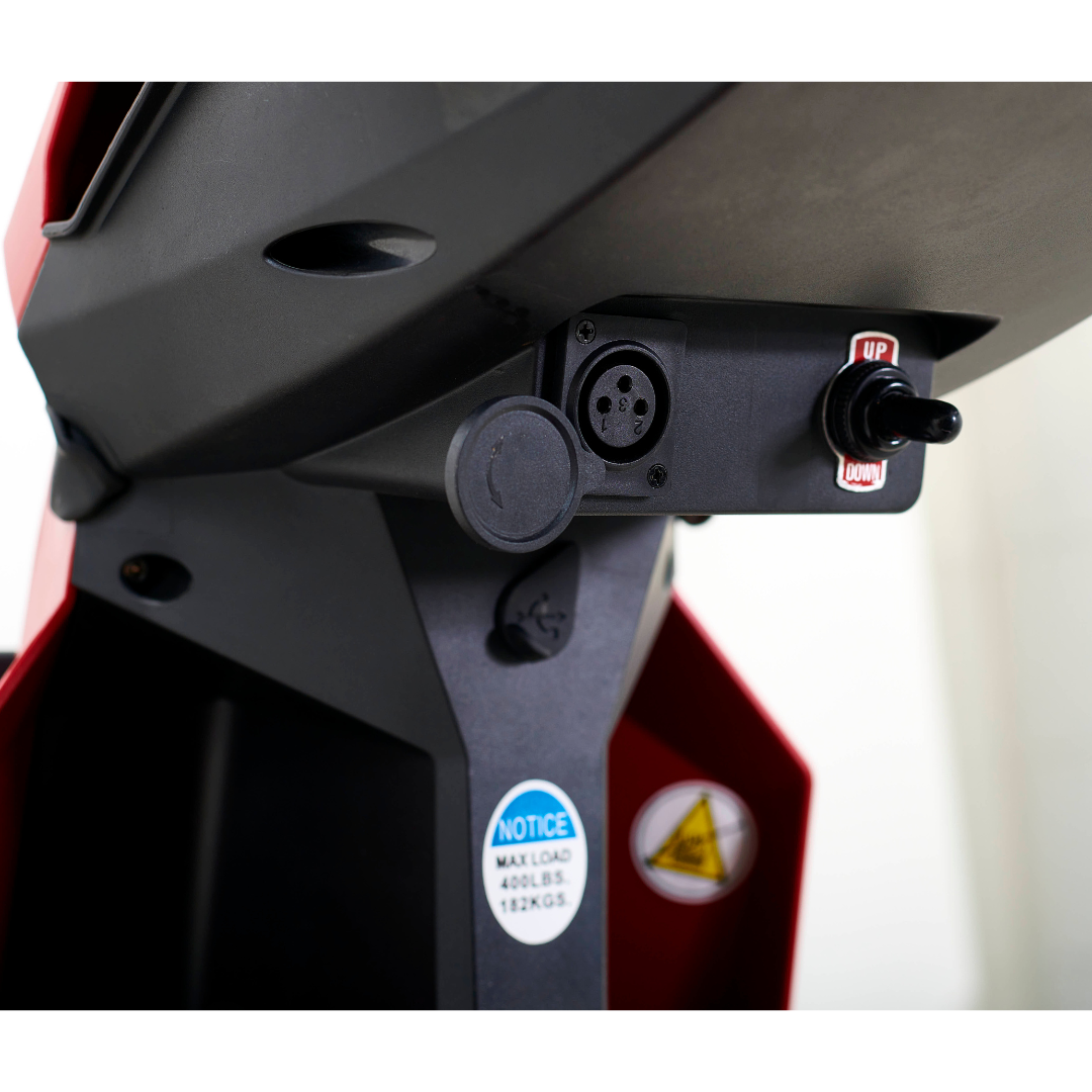 Close-up of the Golden Tech GC340 Companion Full-Size Bariatric Mobility Scooters control panel, featuring a toggle switch marked Up and Down, a circular connector socket, a 400 lbs (182 kg) max load warning, and an adjustable tiller.