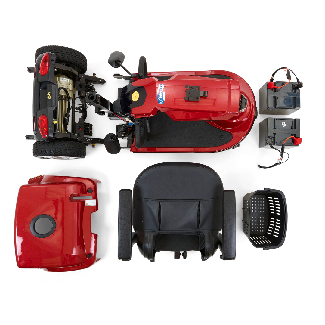 Top view of a disassembled red Golden Tech GC340 Companion Full-Size Bariatric Mobility Scooter with parts including the main body, adjustable tiller, high-back stadium-style seat, shroud, basket, and two batteries arranged neatly on a white background.