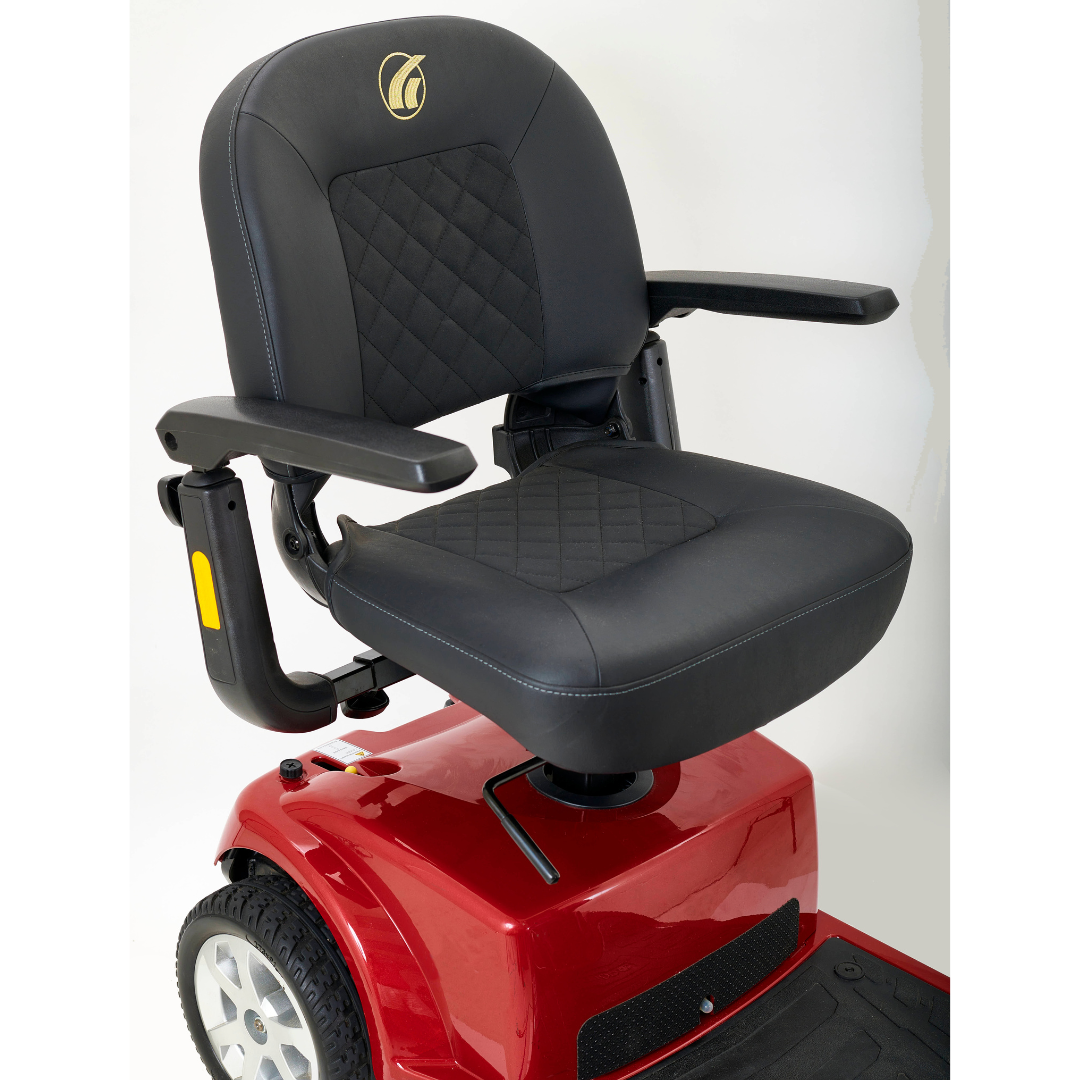 A black padded high-back seat with diamond stitching sits on the red Golden Tech GC340 Companion Full-Size Bariatric Mobility Scooter. It includes armrests, an adjustable tiller, and a swivel seat for easy maneuverability against a plain white background.