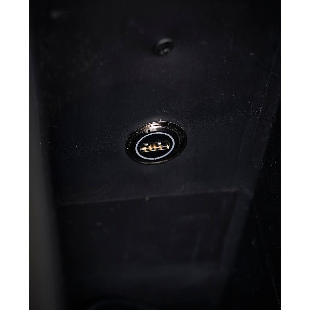Close-up of a single USB port with gold connectors, embedded in the dark surface of the Golden Tech PR525 Cloud+ Recliner With Lift Assist & Twilight - SM.