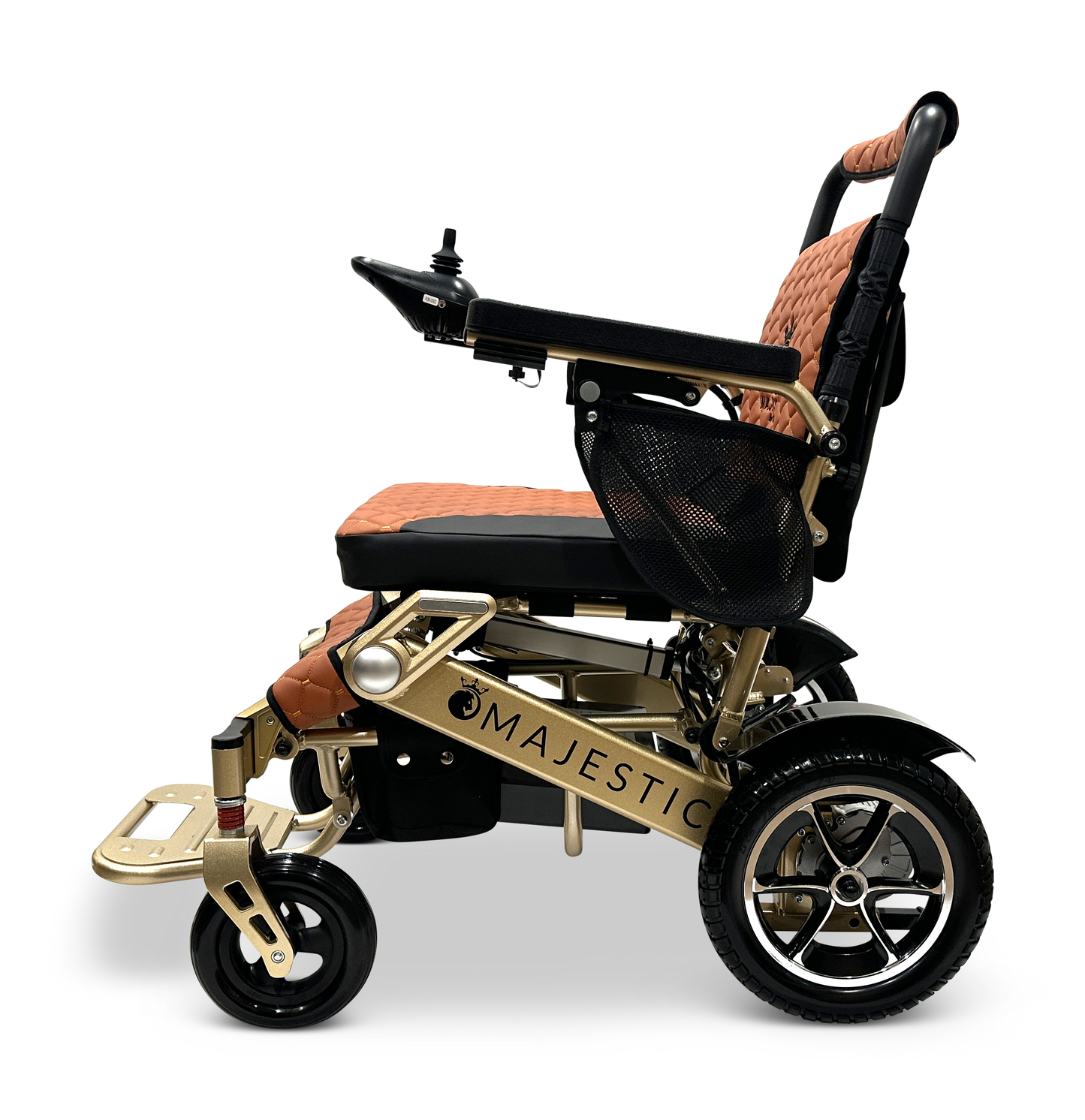 The MAJESTIC IQ-7000 is a gold-colored auto-folding electric wheelchair with brown and black cushioning, featuring a 360-degree joystick on the armrest and small front wheels for easy maneuverability. The lightweight frame displays the name Majestic against a black background.