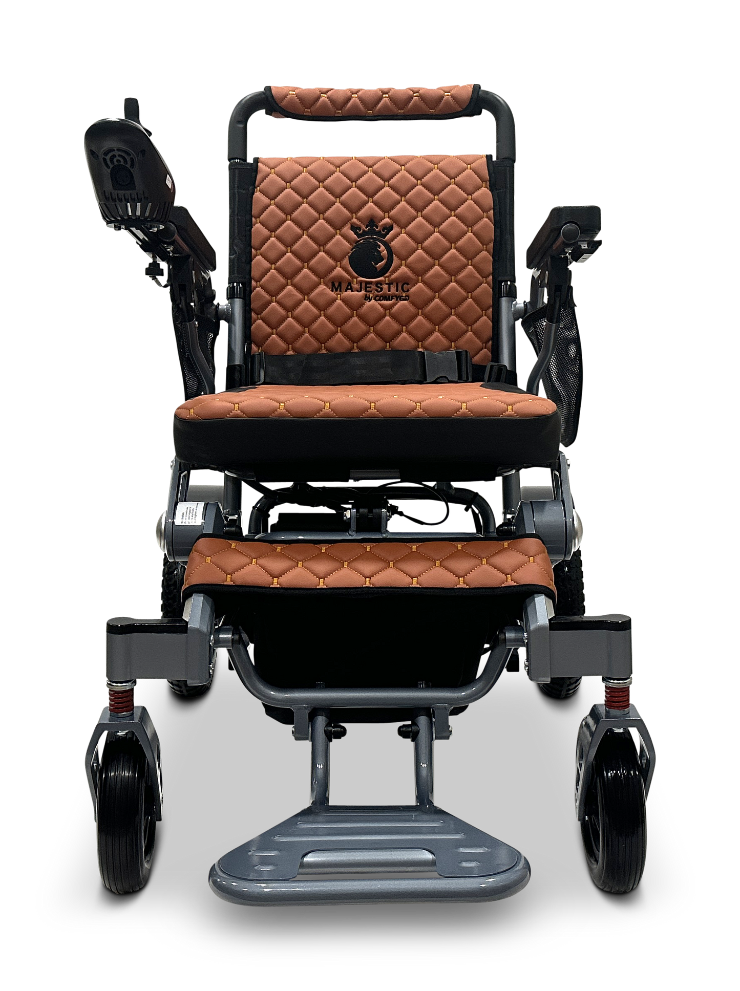 The MAJESTIC IQ-7000 Auto Folding Electric Wheelchair showcases brown quilted leather seating, a sleek black control panel on the armrest, Majestic elegantly embroidered with a crown logo, and a metallic frame with black and silver accents, plus a 360-Degree Joystick for easy navigation.