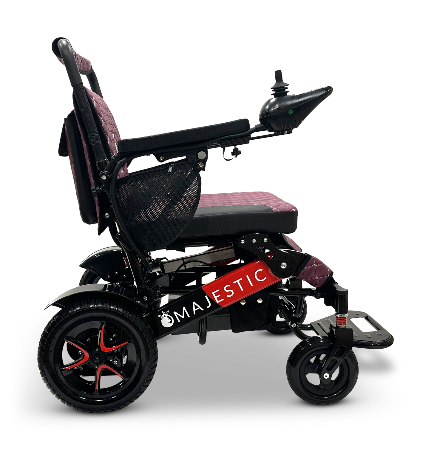 A side view of the MAJESTIC IQ-7000 Remote Controlled Electric Wheelchair showcases its sleek red and black color scheme, featuring an intelligent joystick control on the armrest, a cushioned seat, and large rear wheels for enhanced mobility. The brand name "MAJESTIC" is prominently displayed on the frame.