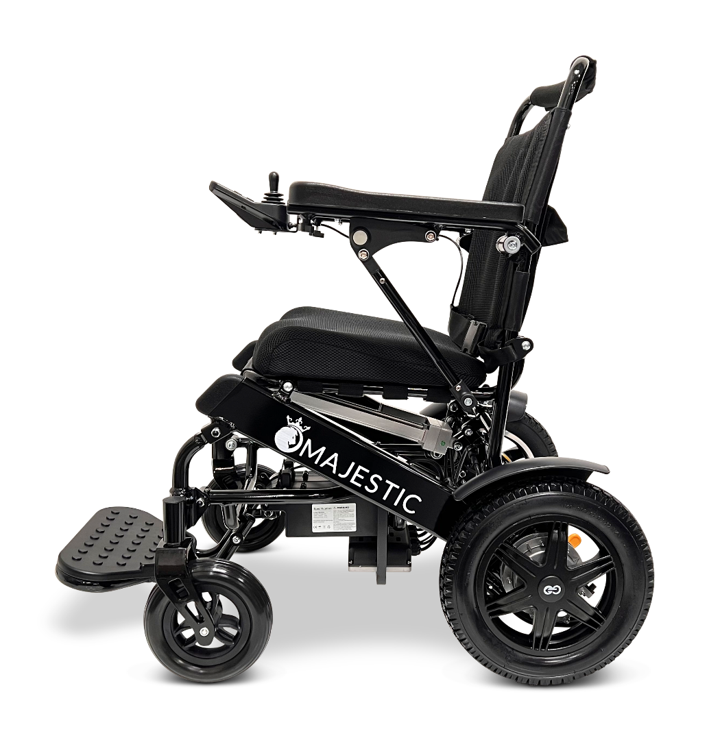 Side view of the ComfyGo MAJESTIC IQ-9000 Auto Reclining Electric Wheelchair in black, featuring a cushioned seat, large rear wheels, small front wheels, armrests, “Majestic” branding, and a digital joystick controller for easy navigation.