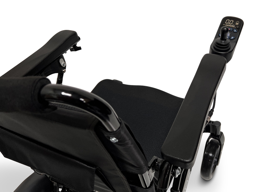Close-up view of the ComfyGo MAJESTIC IQ-9000 Auto Reclining Electric Wheelchair, showcasing its armrest, seat, and digital joystick controller with display. Made from aircraft-grade aluminum alloy. Transparent background.