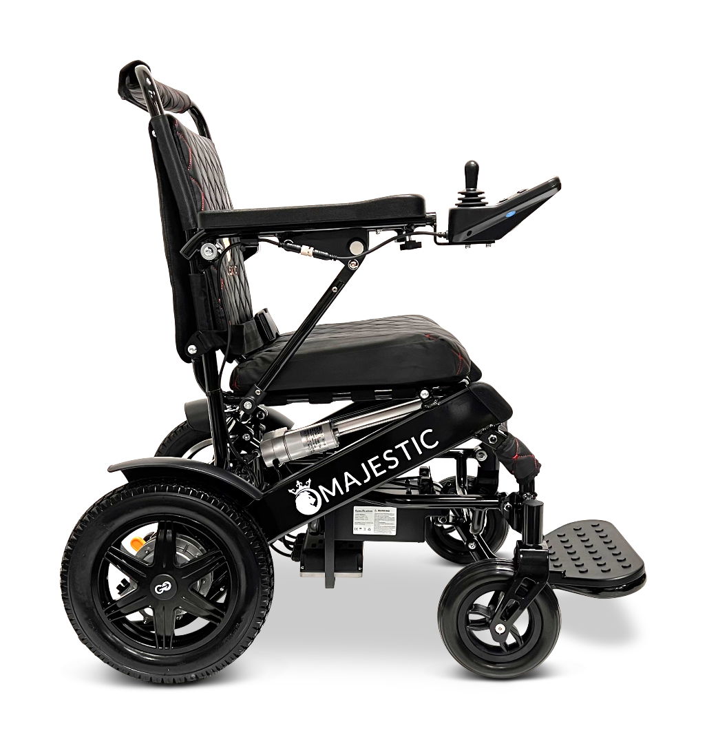 The ComfyGo MAJESTIC IQ-9000 Auto Reclining Electric Wheelchair features the Majestic logo, padded seat, armrests, right-side digital joystick, large rear wheels, and footrest. Made from aircraft-grade aluminum alloy and shown side view on a white background.