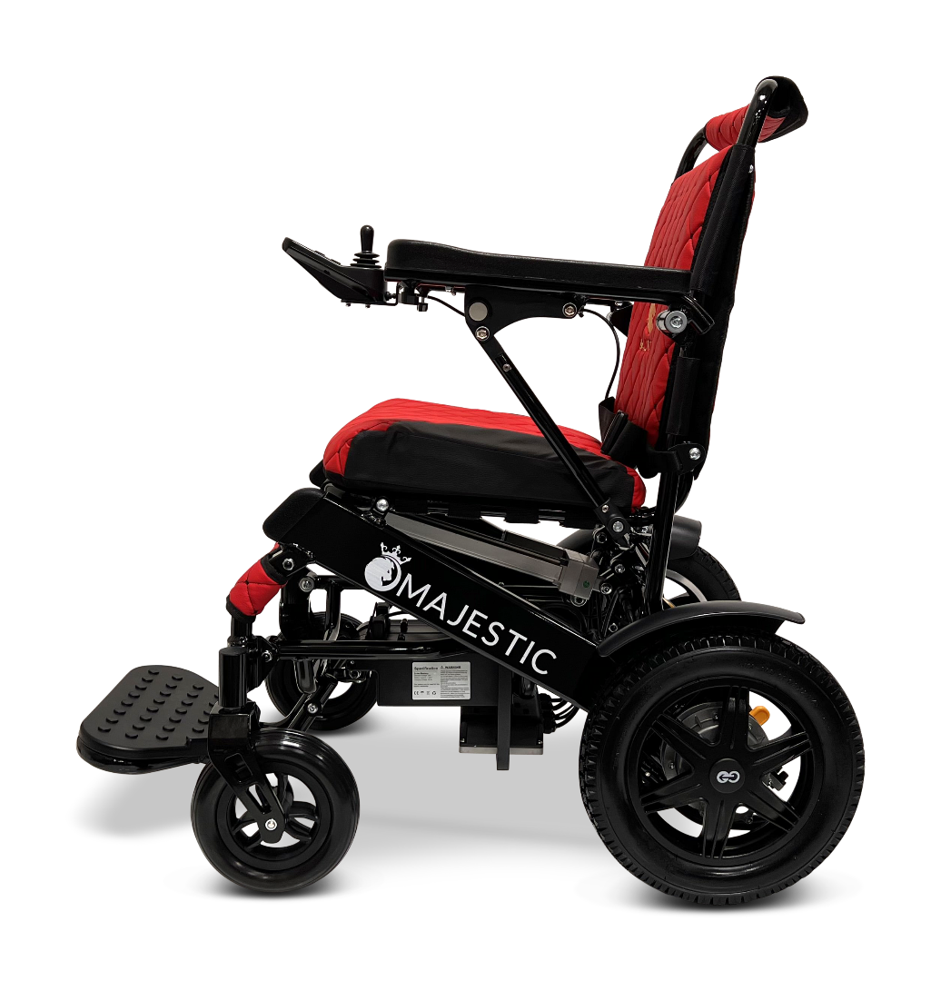 A side view of the ComfyGo MAJESTIC IQ-9000 Auto Reclining Electric Wheelchair in black and red, built from aircraft-grade aluminum alloy, with a padded seat, footrest, armrests, large rear wheels, and “Majestic” on the frame.