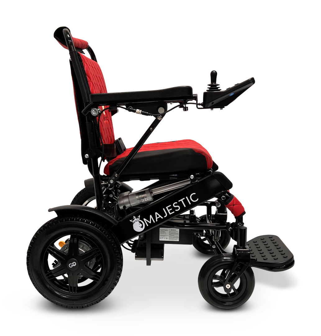 Side view of the ComfyGo MAJESTIC IQ-9000 Auto Reclining Electric Wheelchair in black and red, featuring a digital joystick on the right armrest, padded seat and backrest, aluminum alloy frame, and brushless silent motors for smooth operation.