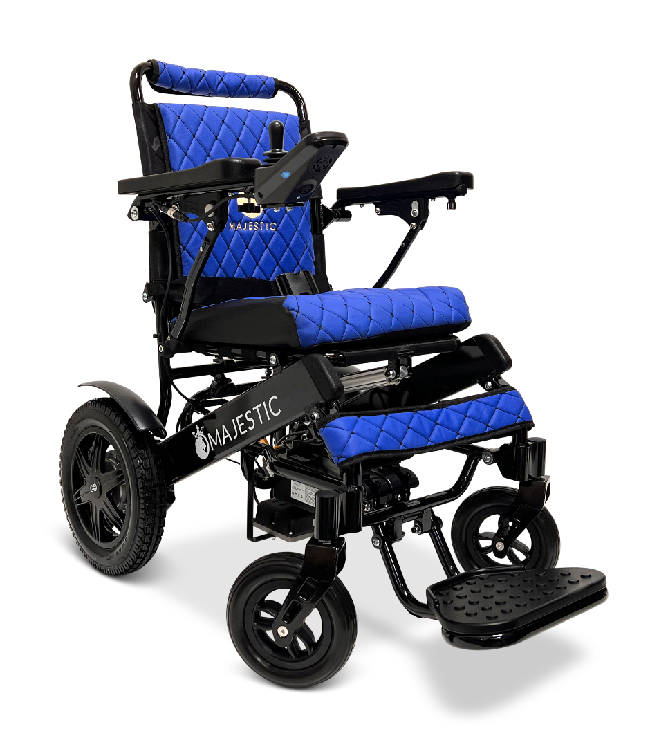The ComfyGo MAJESTIC IQ-9000 Auto Reclining Electric Wheelchair features a black aircraft-grade aluminum alloy frame, large rear wheels, blue quilted cushions, digital joystick armrest controls, and an adjustable footrest with the Majestic logo.