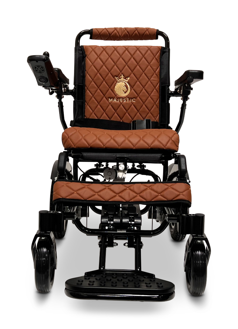 The ComfyGo MAJESTIC IQ-9000 Auto Reclining Electric Wheelchair features black aircraft-grade aluminum, rich brown quilted leather, a gold Majestic logo on the back, digital joystick controller (right armrest), and a sturdy front footrest.