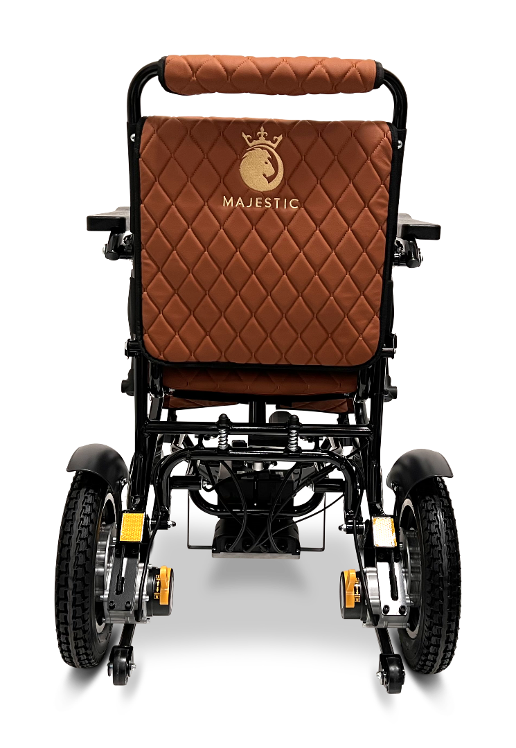 A rear view of the ComfyGo MAJESTIC IQ-9000 Auto Reclining Electric Wheelchair, brown and quilted with a black aircraft-grade aluminum alloy frame, large wheels, and Majestic plus a crown logo embroidered on the backrest.