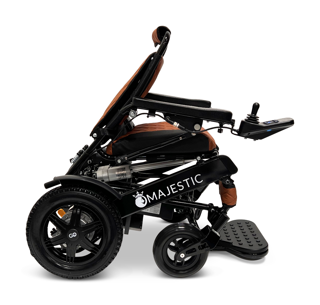 Side view of the ComfyGo MAJESTIC IQ-9000 Auto Reclining Electric Wheelchair in black and brown, featuring an aircraft-grade aluminum frame, armrests, footrest, front and rear wheels, and a right-arm digital joystick controller. Majestic appears on the frame.