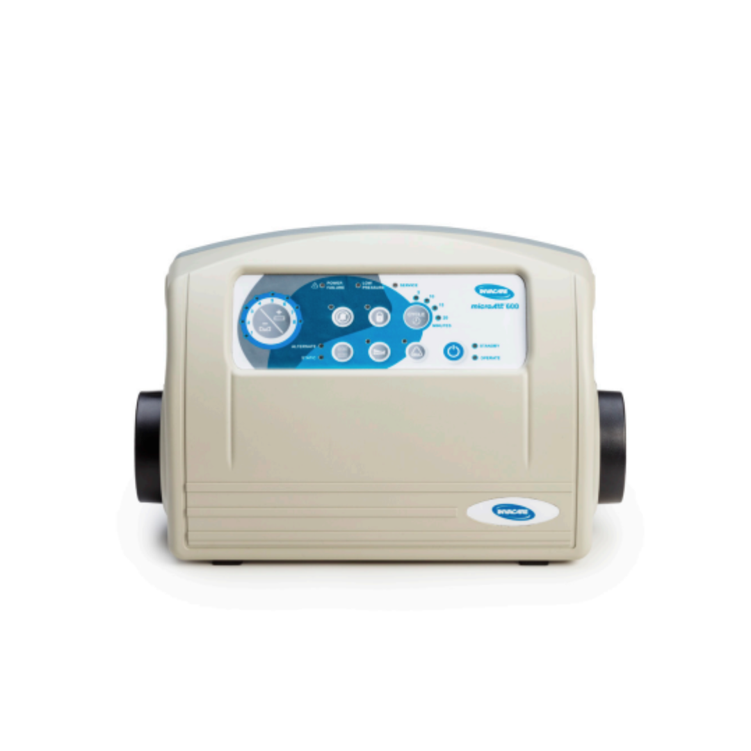 A beige electronic control box with a blue and white panel labeled āInvacare microAIRĀ® MA600 3-in-1 Alternating Pressure LAL Mattress System,ā featuring buttons, a dial, and indicator lights against a white background.